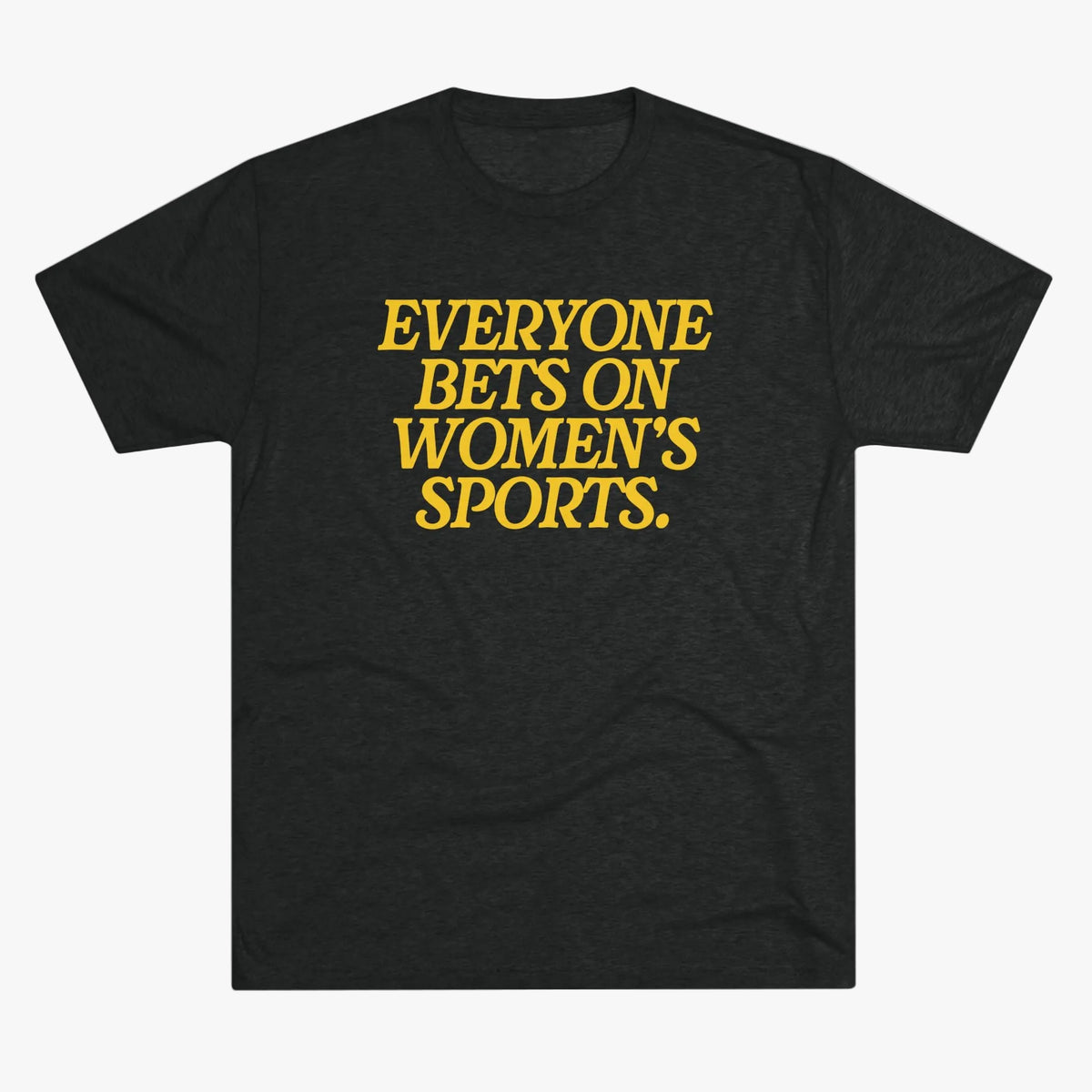 A dark heather gray short-sleeve t-shirt with bold yellow text on the chest that reads 'EVERYONE BETS ON WOMEN'S SPORTS.' against a plain white background.