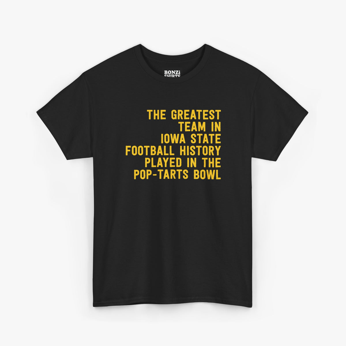 Black t-shirt with gold text reading The Greatest Team In Iowa State Football History Played In The Pop-Tarts Bowl, laid flat on a light gray background