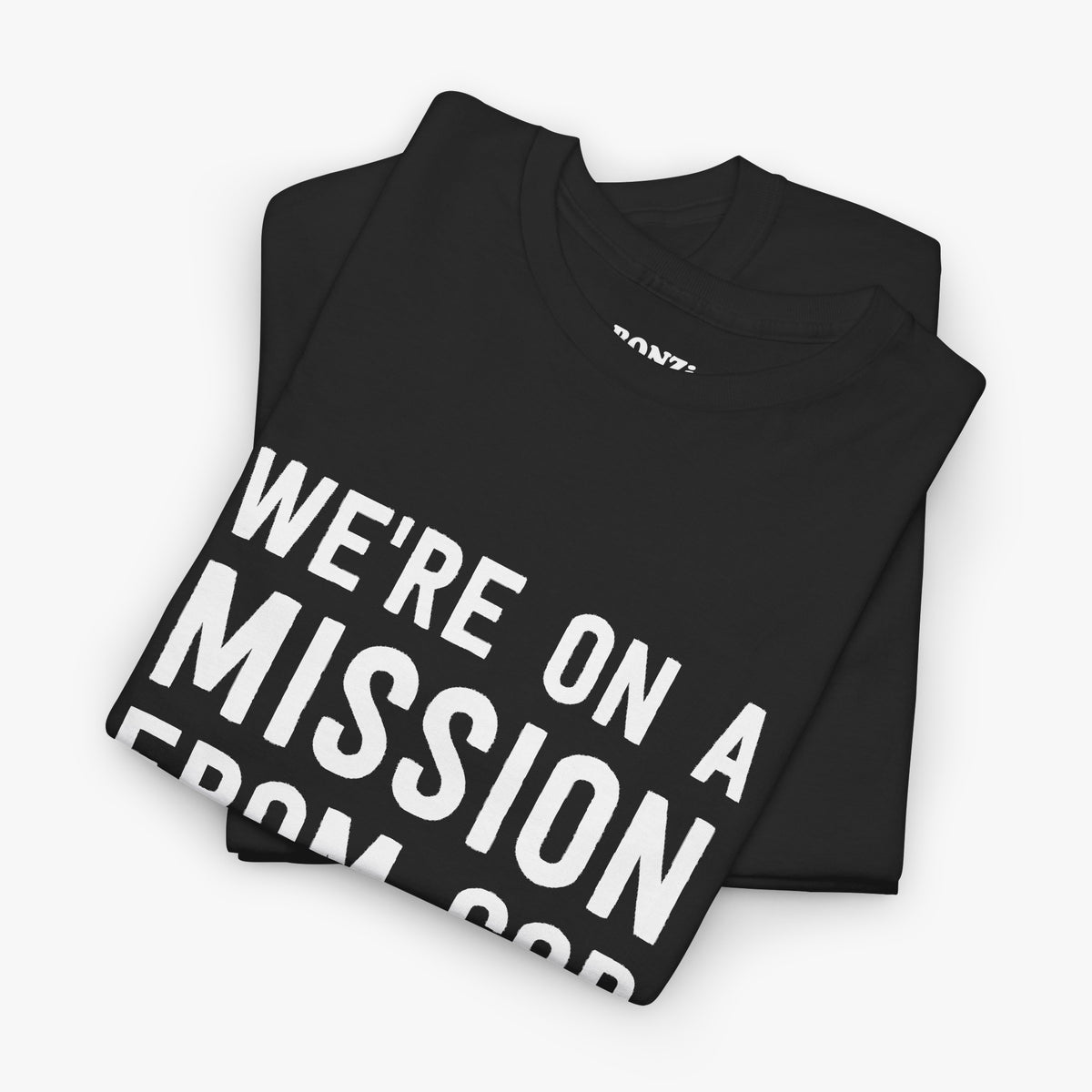 Folded black t-shirt showing the We're On A Mission From God design and the BONZi neck label