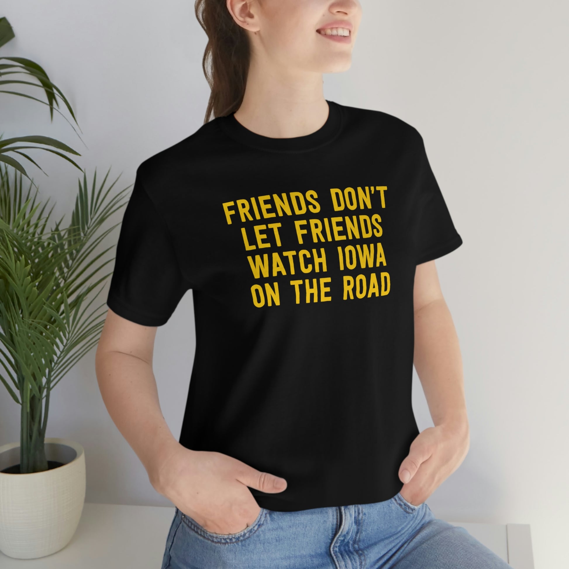 Friends Don't Let Friends Watch Iowa On The Road Shirt in Black and Gold - Female Casual Model